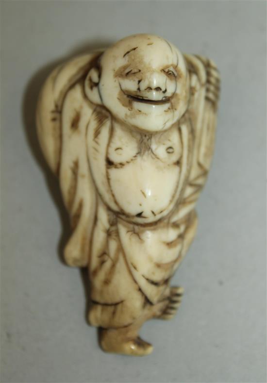 A Japanese ivory netsuke of Hotei, 18th / 19th century, 5.5cm, age cracks